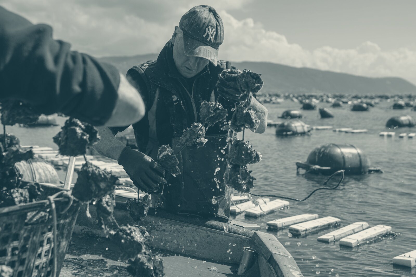 A man standing on top of a boat in the water