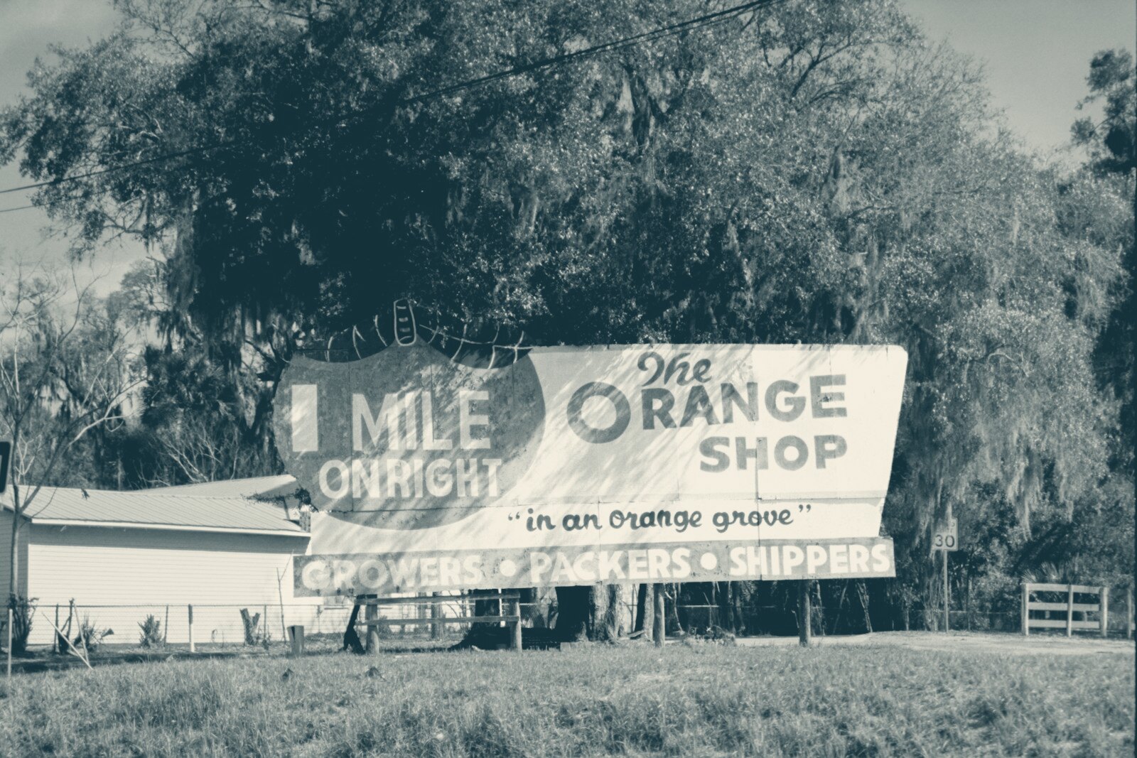 The orange shop billboard with 1 mile sign